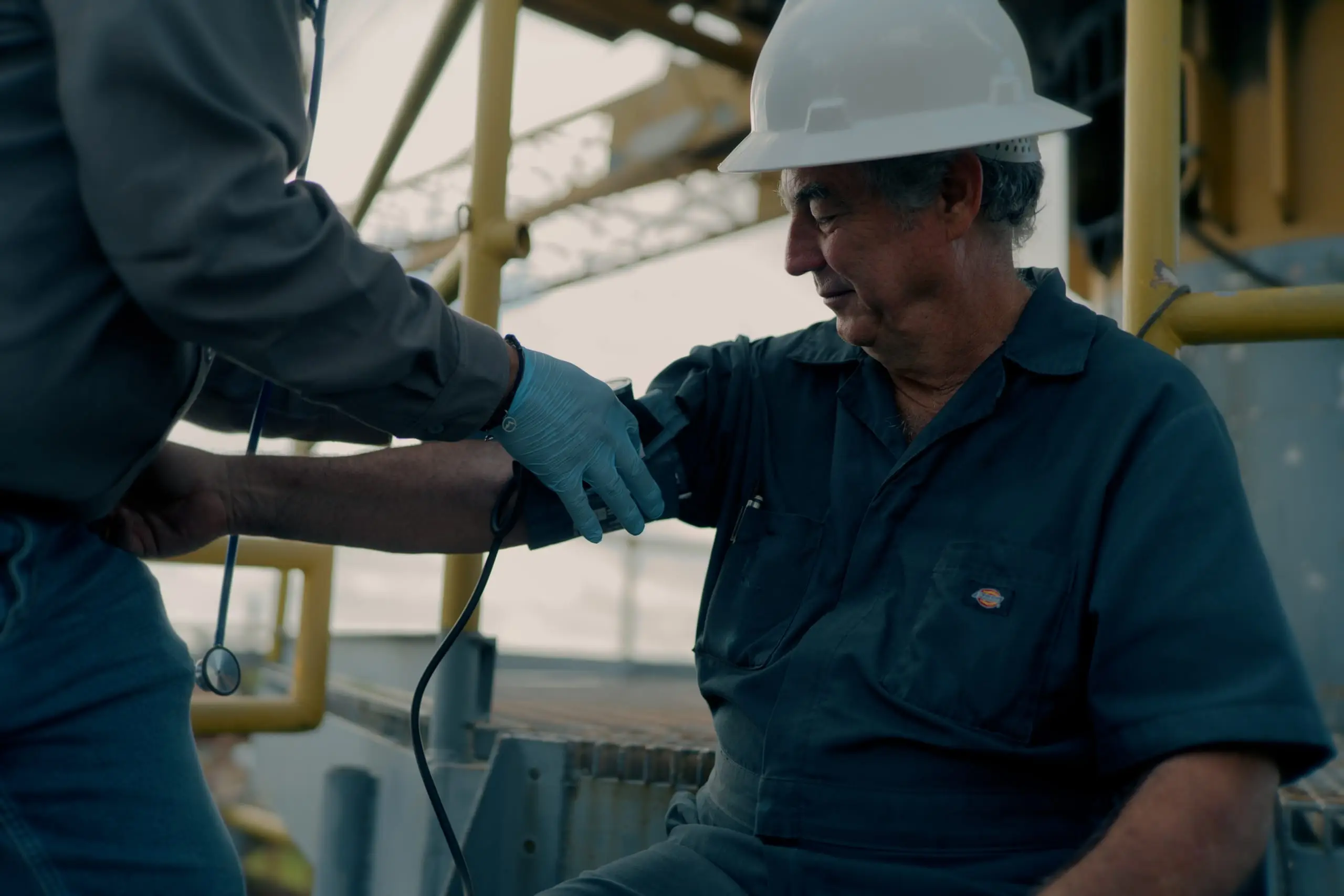 An On Site medic checking a worker's vitals on a rig